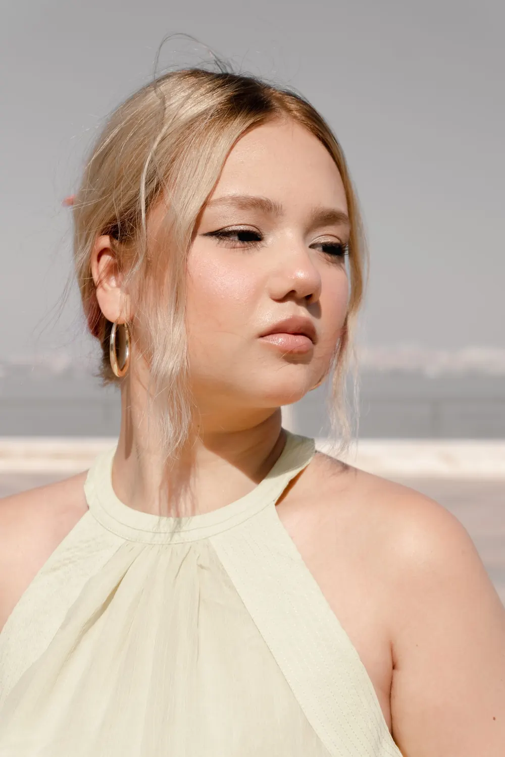 Beautiful portrait of a young woman enjoying a sunny day outdoors.